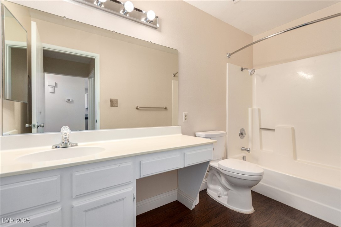 6465 West Plumcrest Road Las Vegas, NV 89108 - Photo 26 of 34 Bathroom with shower combination, vanity, and dark wood-style floors