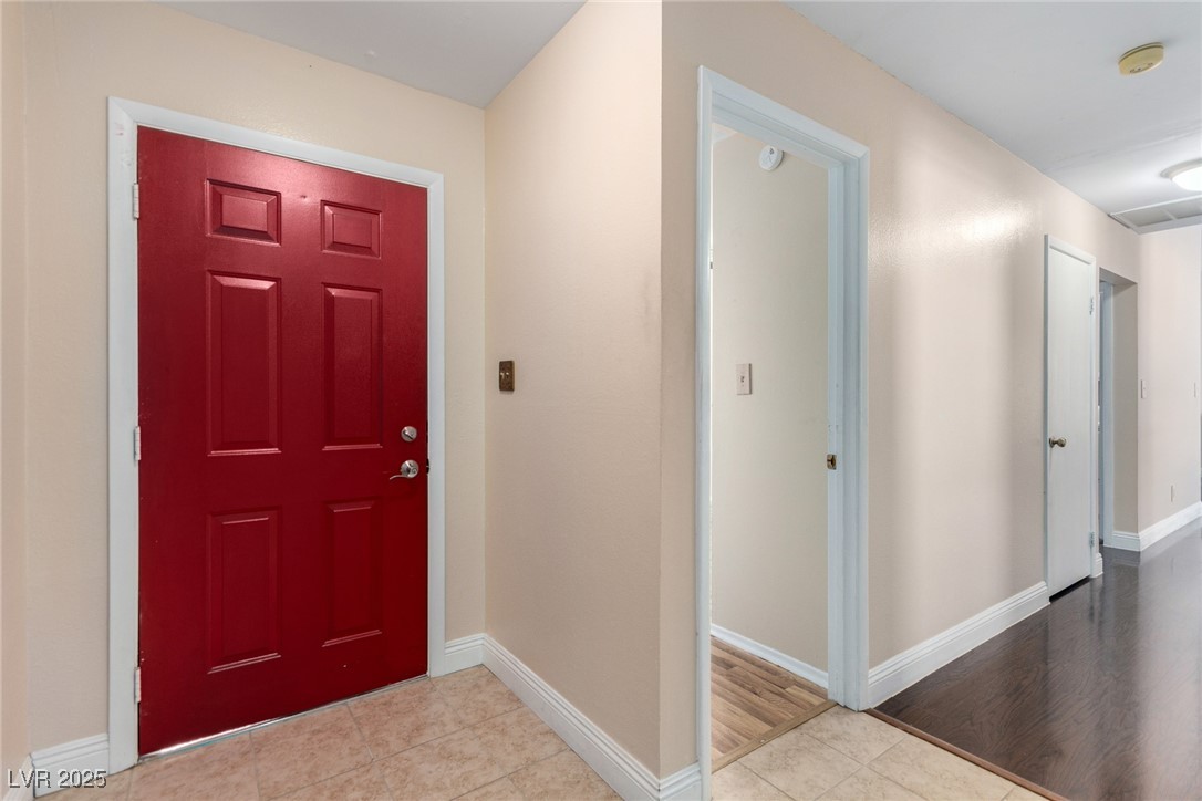 6465 West Plumcrest Road Las Vegas, NV 89108 - Photo 9 of 34 Entrance foyer featuring baseboards and tile patterned floors