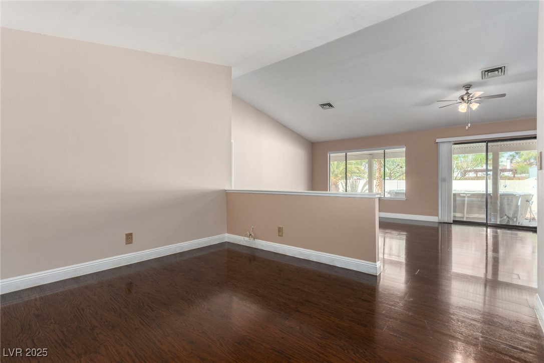 6465 West Plumcrest Road Las Vegas, NV 89108 - Photo 10 of 34 Spare room with dark wood finished floors, lofted ceiling, and ceiling fan