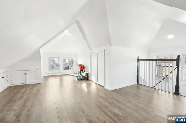 a view of a livingroom with wooden floor and white walls