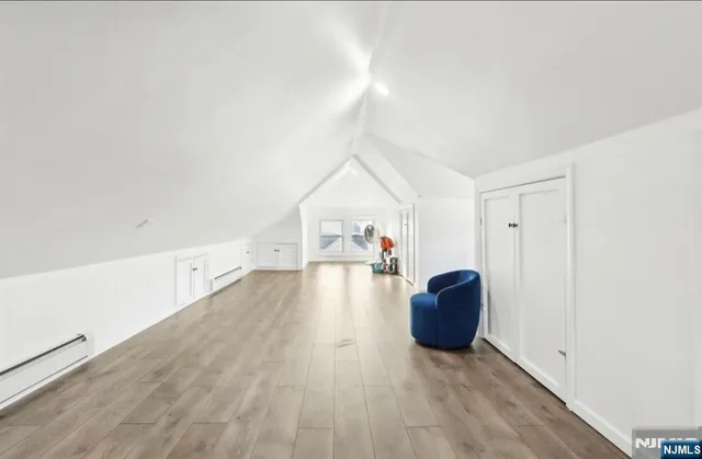 a view of a livingroom with wooden floor and furniture