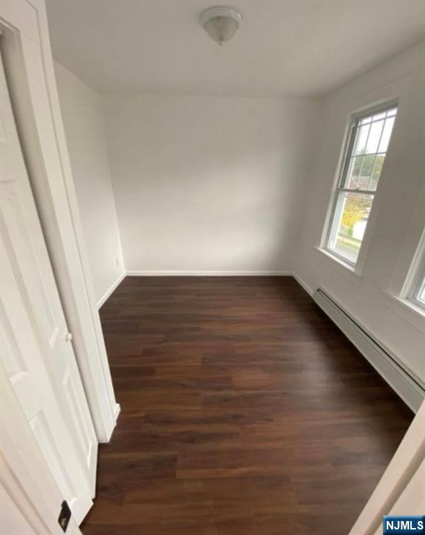20 Borig Place, Unit 2 Lodi, NJ 07644 - Photo 9 of 11 a view of an empty room with wooden floor and a window
