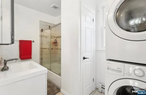a bathroom with a sink and a washer dryer