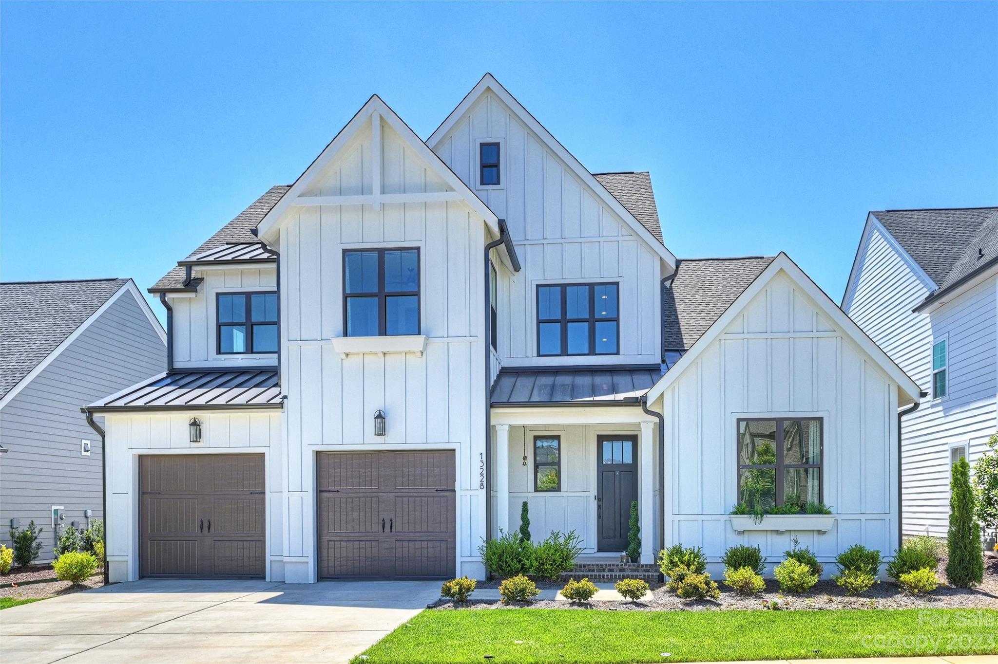 13228 Philip Michael Road Huntersville, NC 28078 - Photo 1 of 39 a front view of a house with a yard and garage