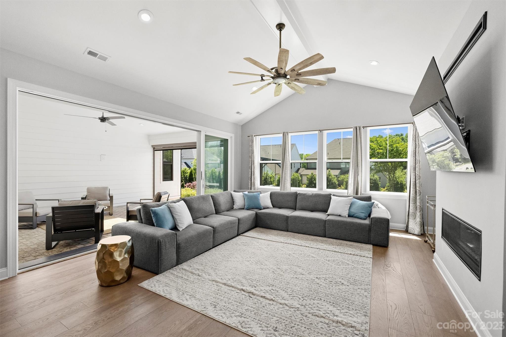 13228 Philip Michael Road Huntersville, NC 28078 - Photo 11 of 39 a living room with furniture a fireplace and a flat screen tv