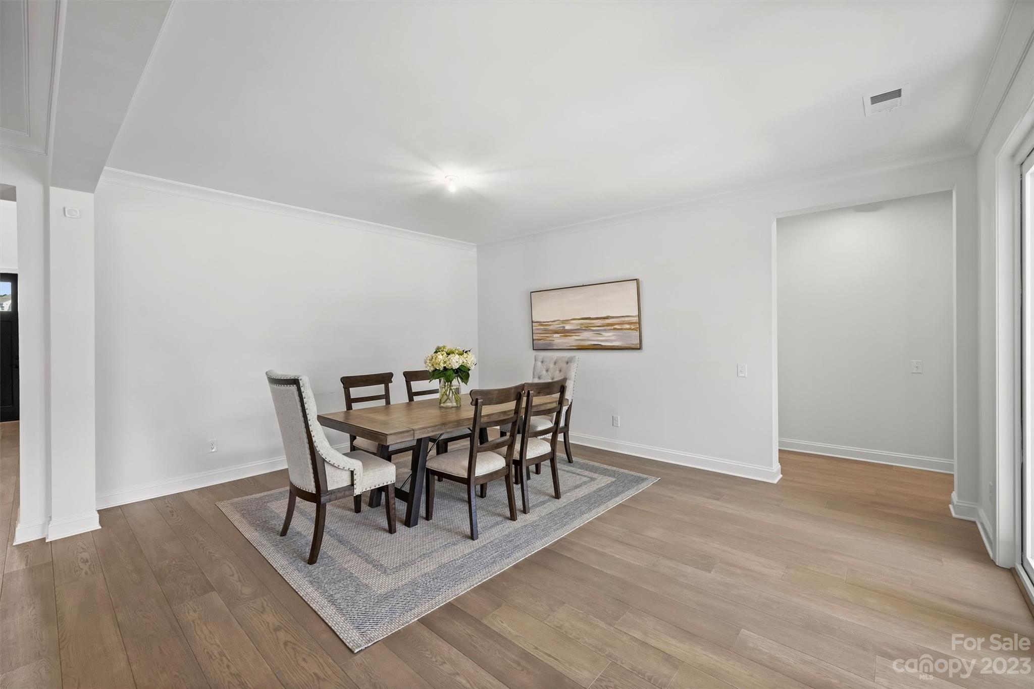 13228 Philip Michael Road Huntersville, NC 28078 - Photo 13 of 39 a view of a dining room with furniture and wooden floor