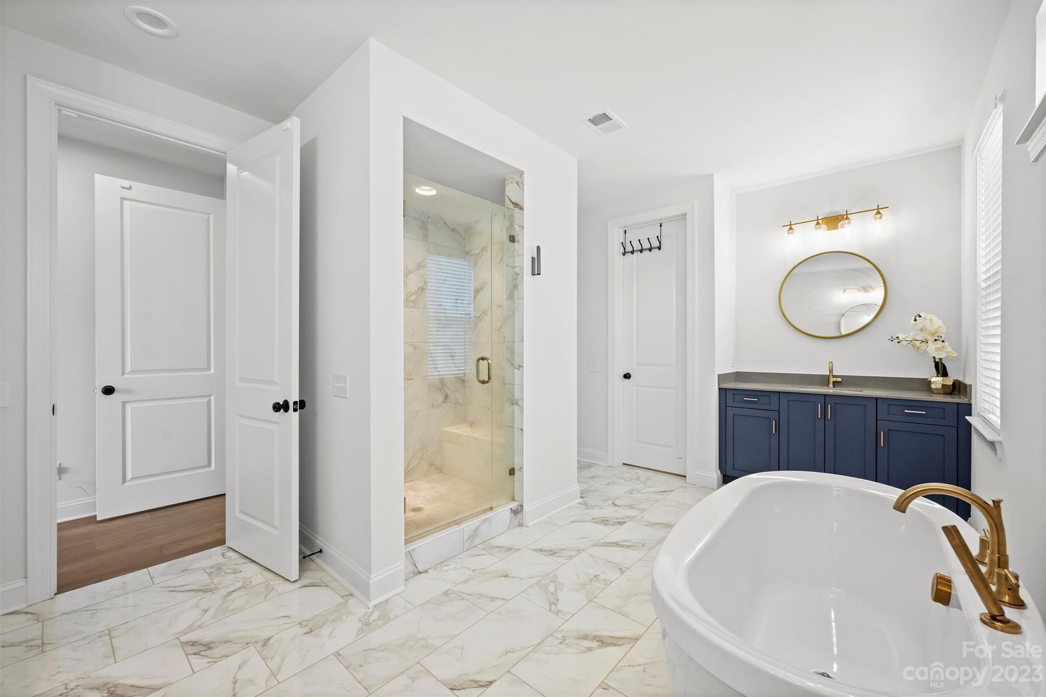 13228 Philip Michael Road Huntersville, NC 28078 - Photo 18 of 39 a bathroom with a tub sink and mirror