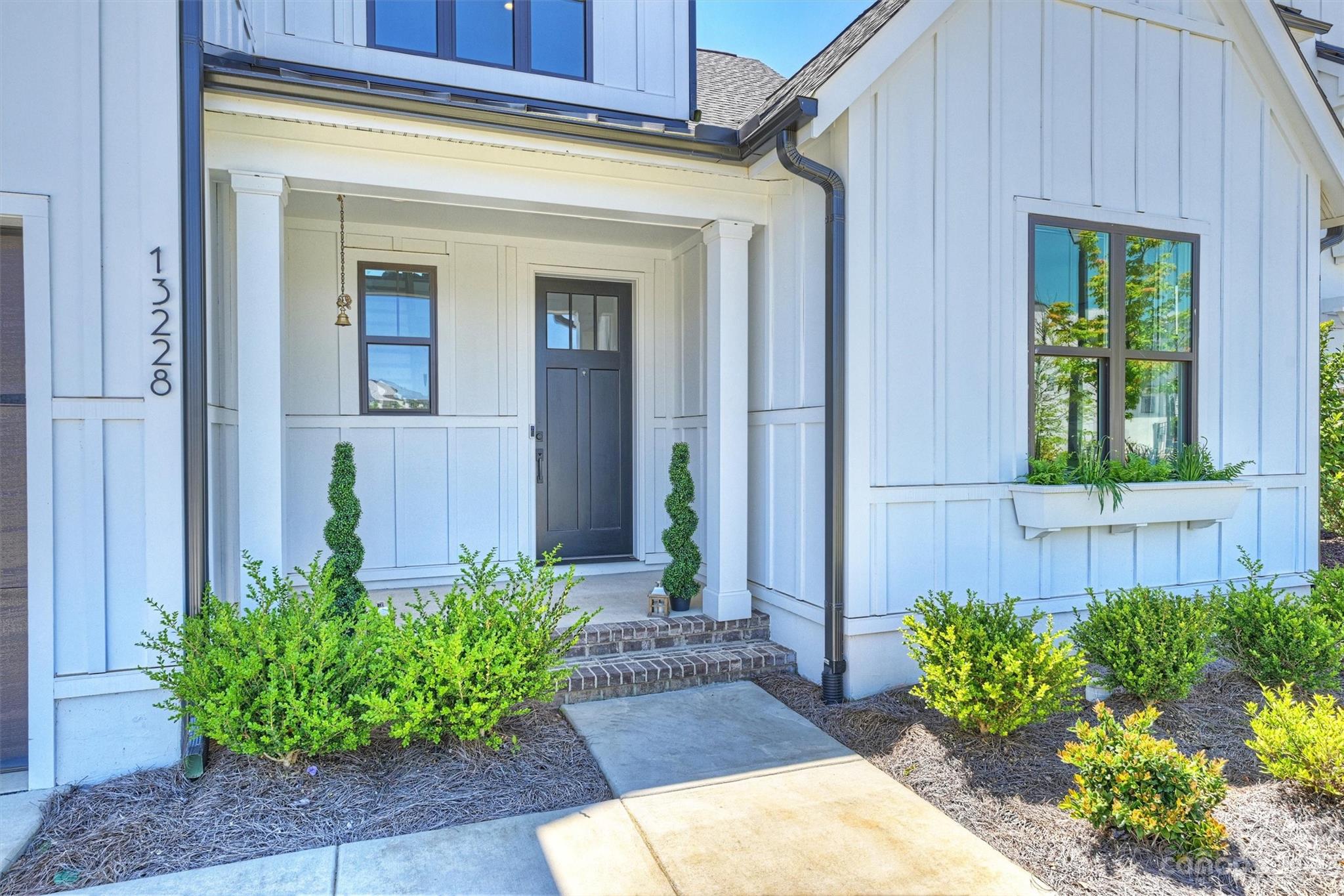 13228 Philip Michael Road Huntersville, NC 28078 - Photo 2 of 39 a front view of a house with garden