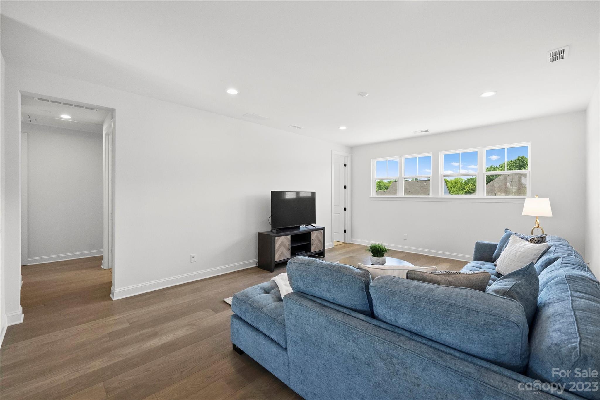13228 Philip Michael Road Huntersville, NC 28078 - Photo 24 of 39 a living room with furniture and a wooden floor