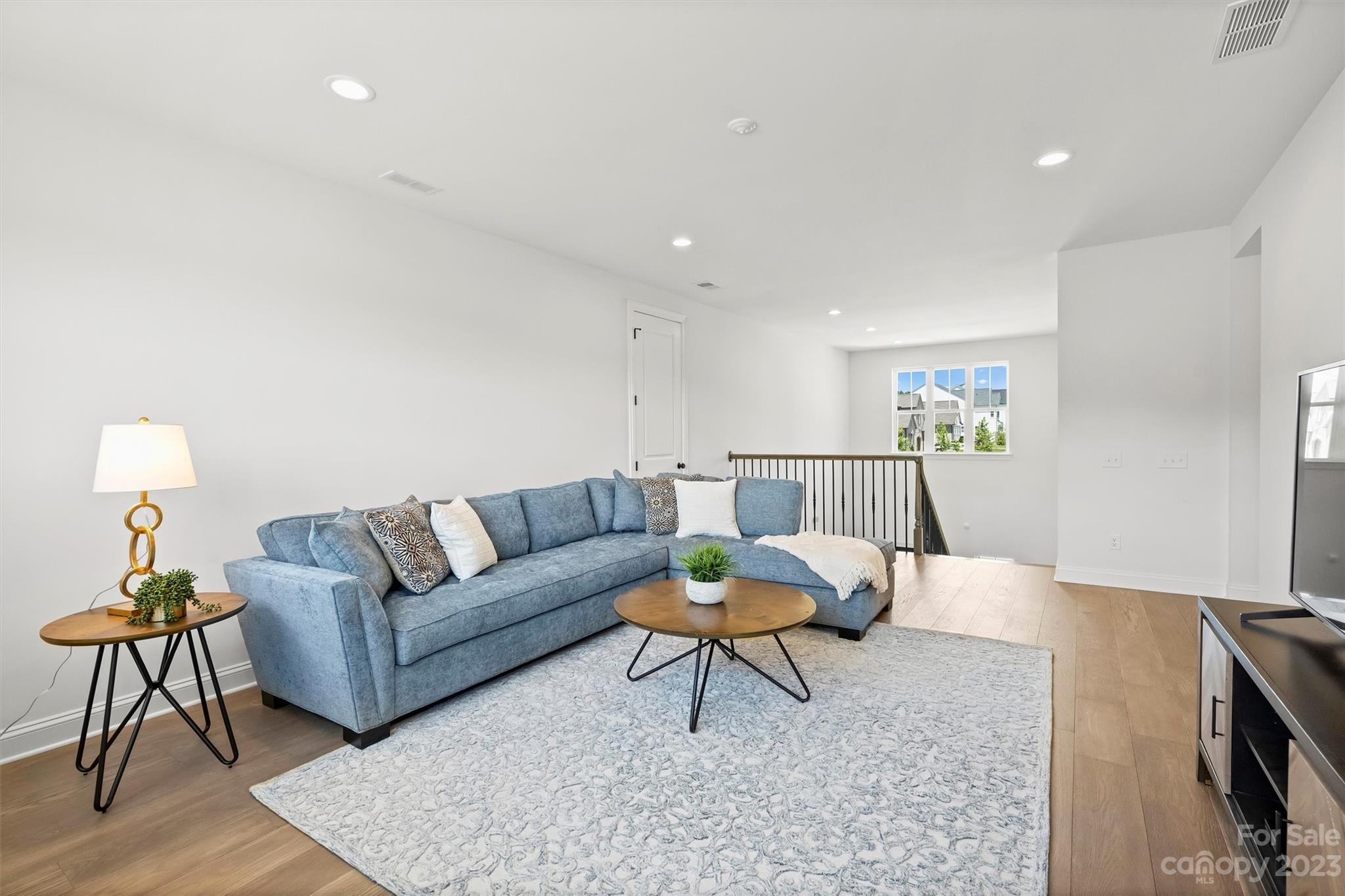 13228 Philip Michael Road Huntersville, NC 28078 - Photo 25 of 39 a living room with furniture and a lamp