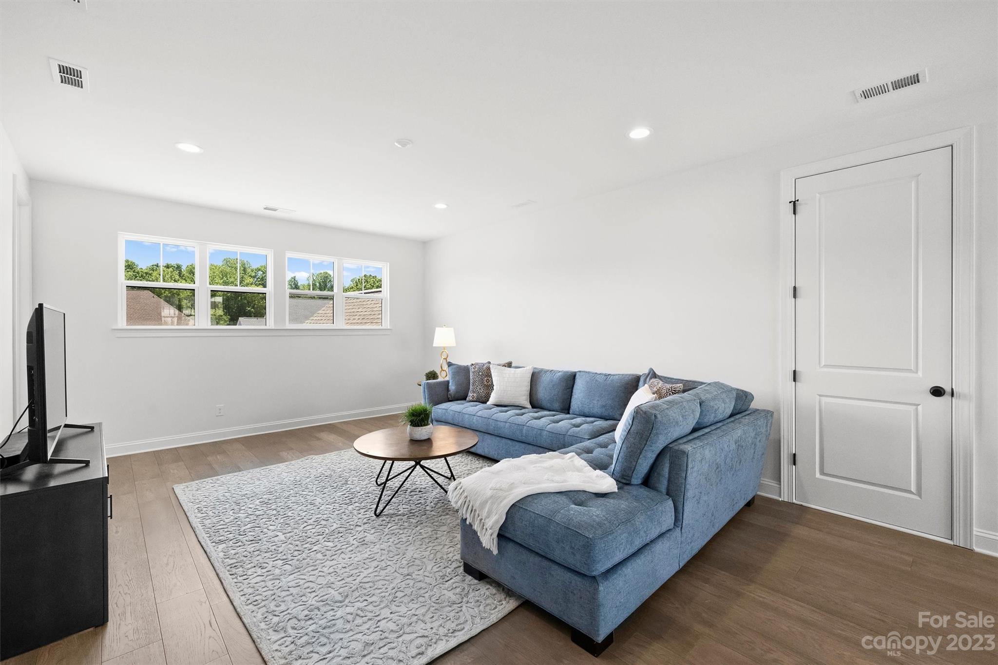 13228 Philip Michael Road Huntersville, NC 28078 - Photo 26 of 39 a living room with furniture and a flat screen tv