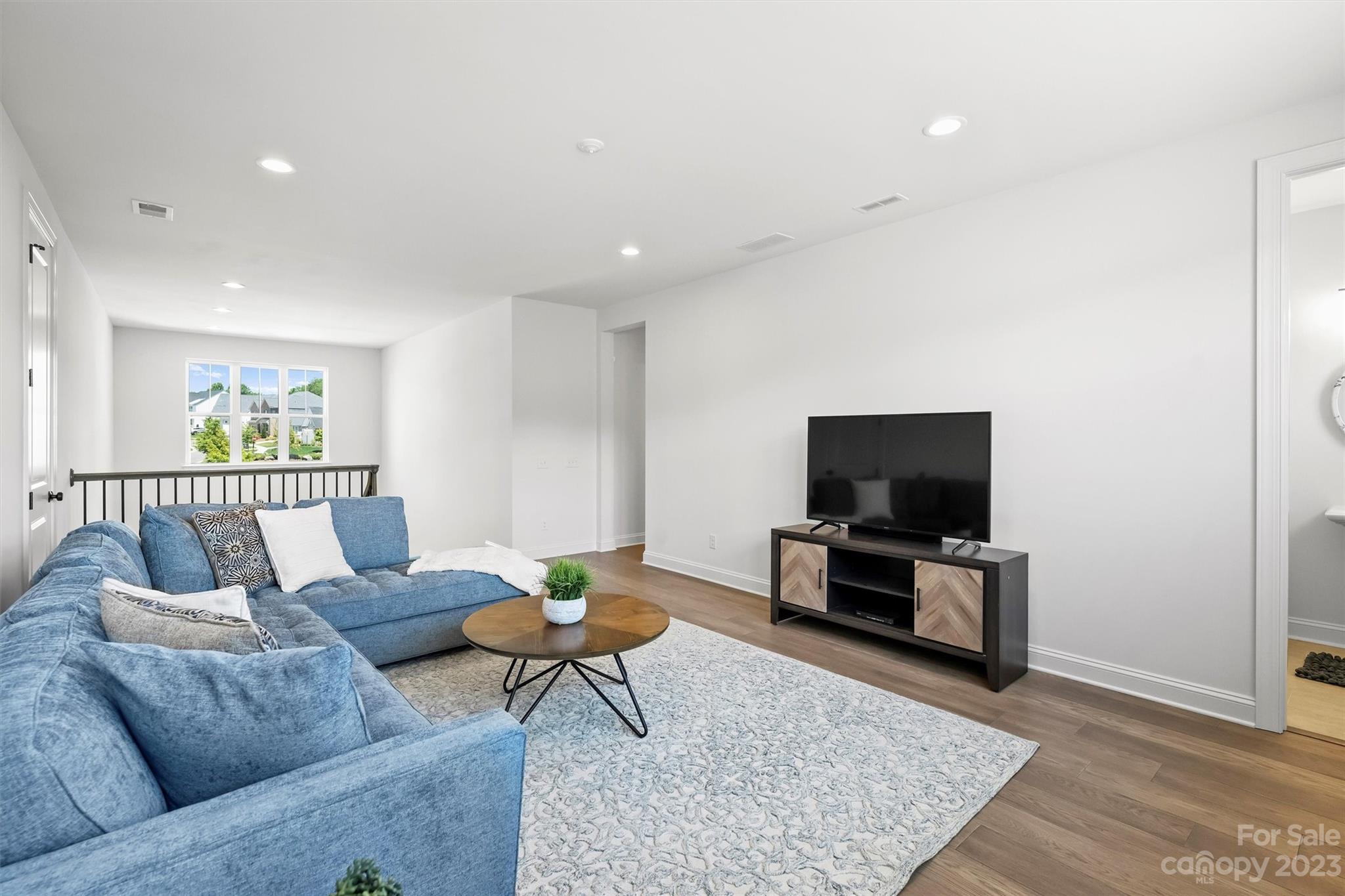 13228 Philip Michael Road Huntersville, NC 28078 - Photo 27 of 39 a living room with furniture and a flat screen tv