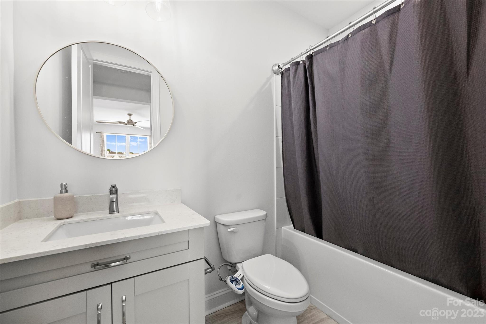 13228 Philip Michael Road Huntersville, NC 28078 - Photo 30 of 39 a bathroom with a sink a toilet and mirror