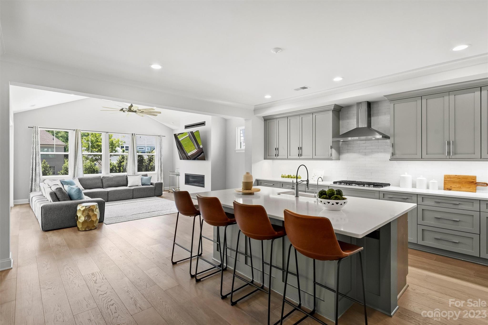 13228 Philip Michael Road Huntersville, NC 28078 - Photo 3 of 39 a kitchen with a dining table chairs and wooden floor