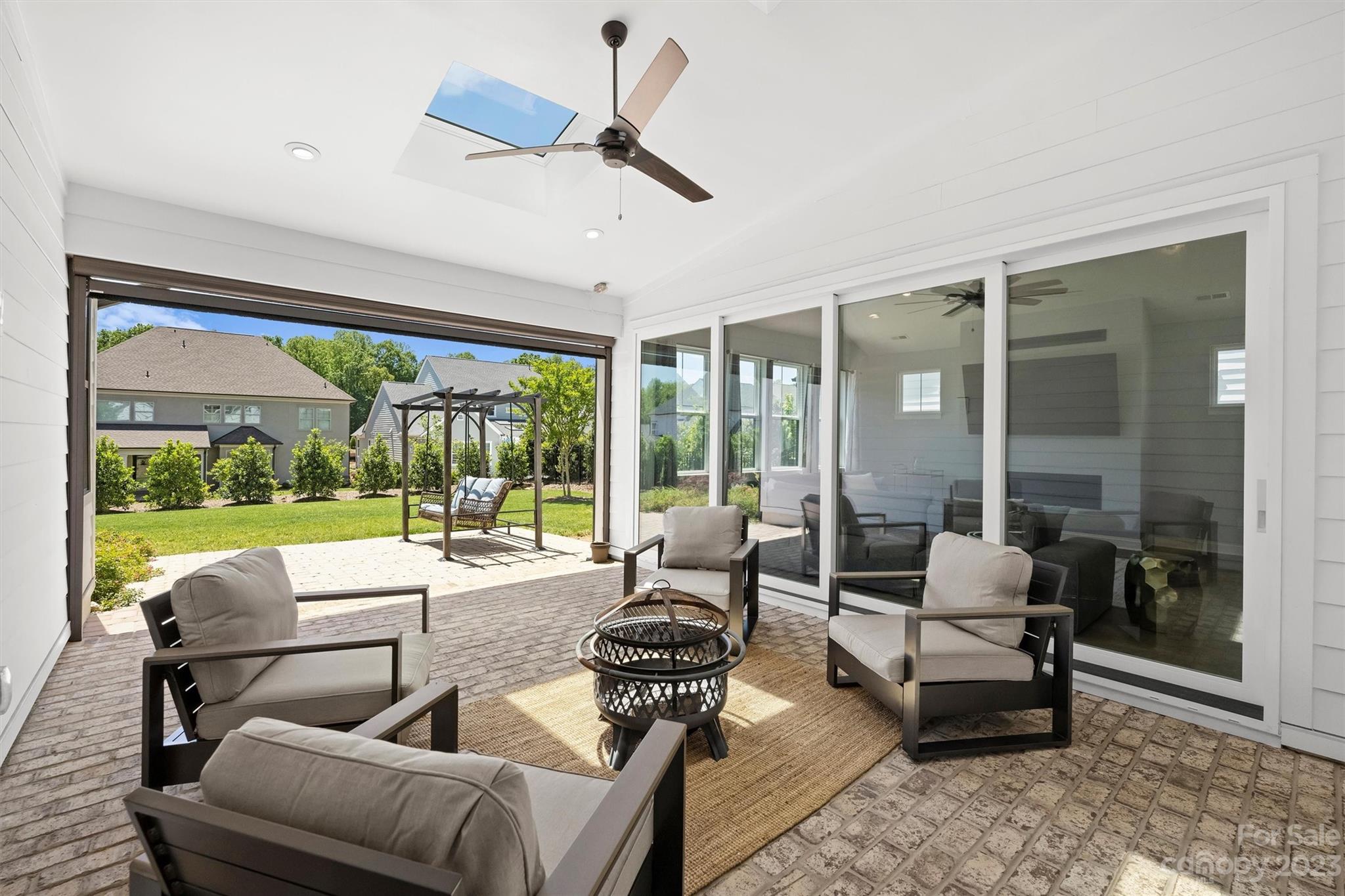 13228 Philip Michael Road Huntersville, NC 28078 - Photo 36 of 39 a living room with furniture and floor to ceiling windows