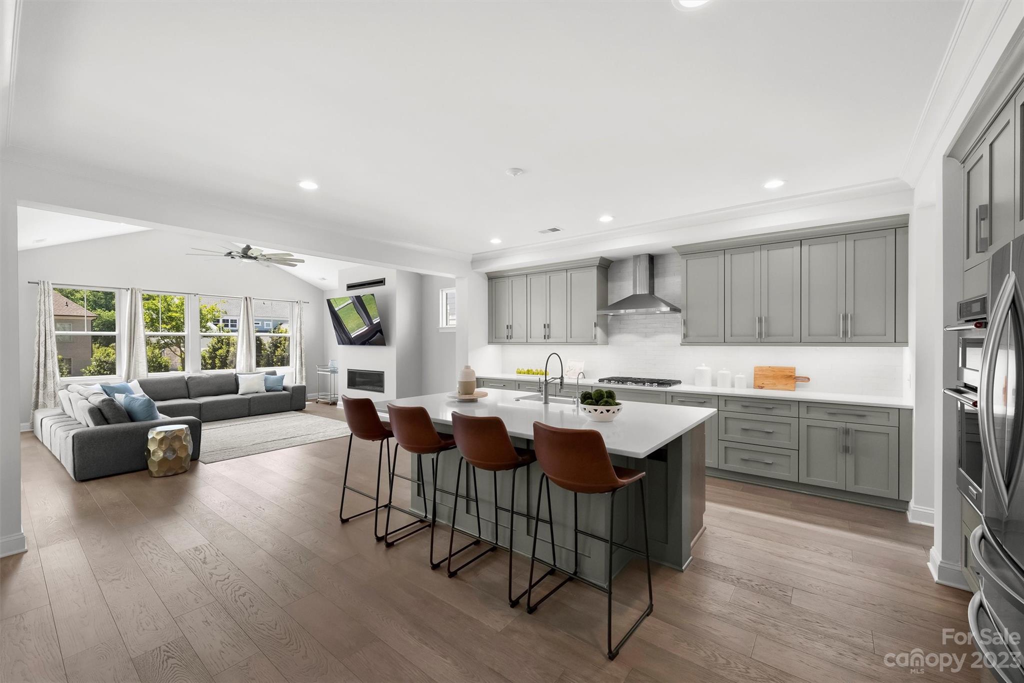 13228 Philip Michael Road Huntersville, NC 28078 - Photo 4 of 39 a large kitchen with kitchen island a sink table and chairs