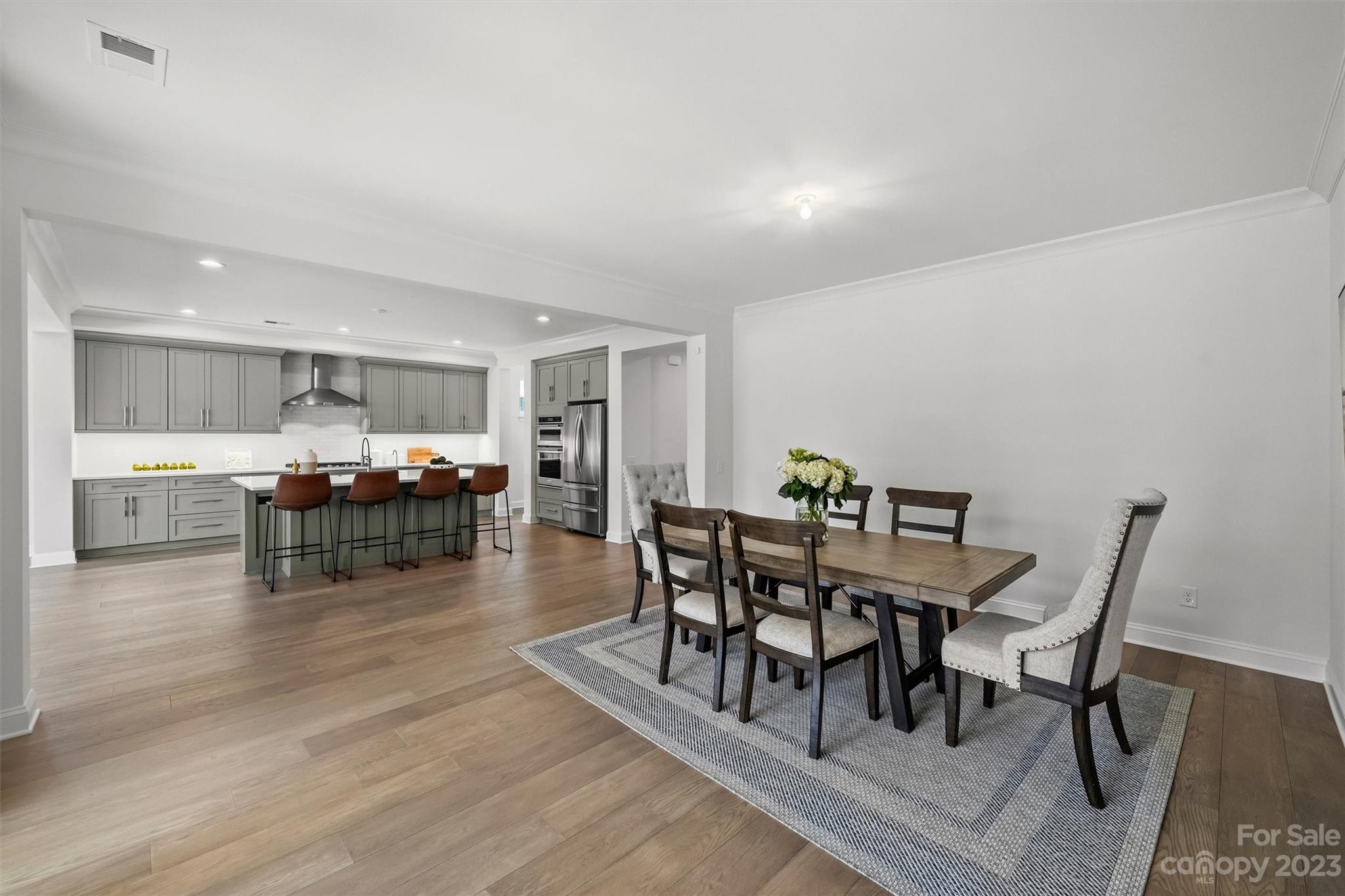 13228 Philip Michael Road Huntersville, NC 28078 - Photo 9 of 39 a dining room with furniture and wooden floor