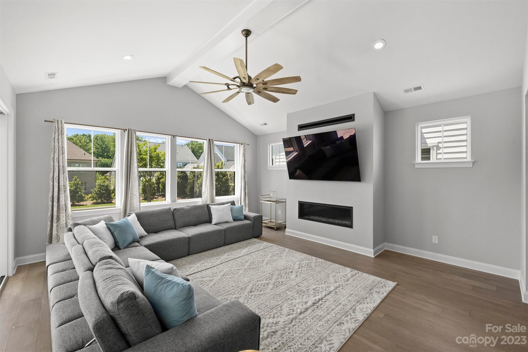 13228 Philip Michael Road Huntersville, NC 28078 - Photo 10 of 39 a living room with furniture a flat screen tv and a fireplace