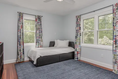 a bedroom with a bed and a large window