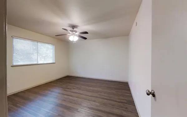 wooden floor in an empty room with a window