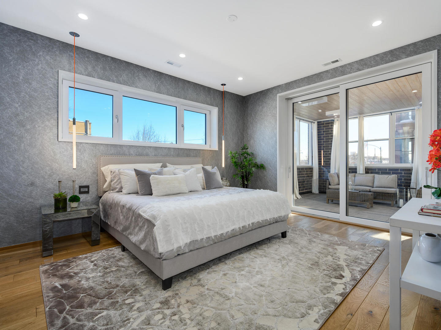 1601 West Ohio Street, Unit 2 Chicago, IL 60622 - Photo 14 of 31 a spacious bedroom with a large bed and a wooden floor