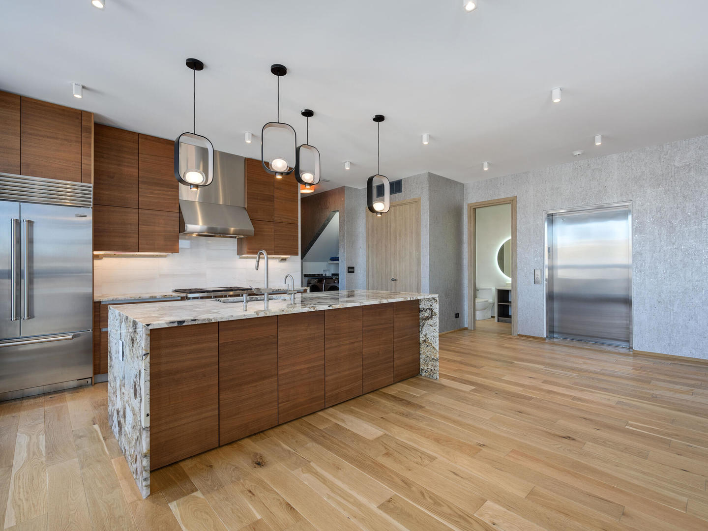 1601 West Ohio Street, Unit 2 Chicago, IL 60622 - Photo 27 of 31 a large kitchen with stainless steel appliances kitchen island granite countertop a sink and a refrigerator