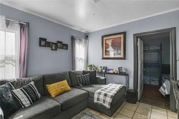 a bedroom with furniture and a large window