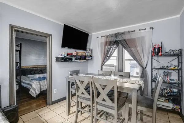 a view of a dining room with furniture and a window