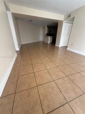a view of a livingroom with an empty space and a fireplace