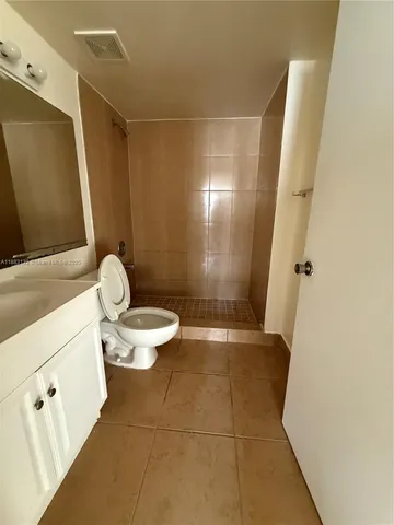 a view of a kitchen with a sink and a refrigerator