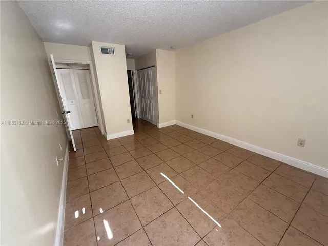 a view of an empty room and wooden floor