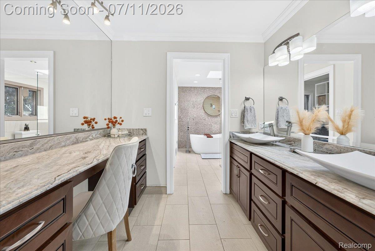 23750 East River Road Grosse Ile, MI 48138 - Photo 22 of 54 Spacious bathroom featuring twin vessel sinks set into a vanity with rich wood-finish cabinetry and a light-toned countertop