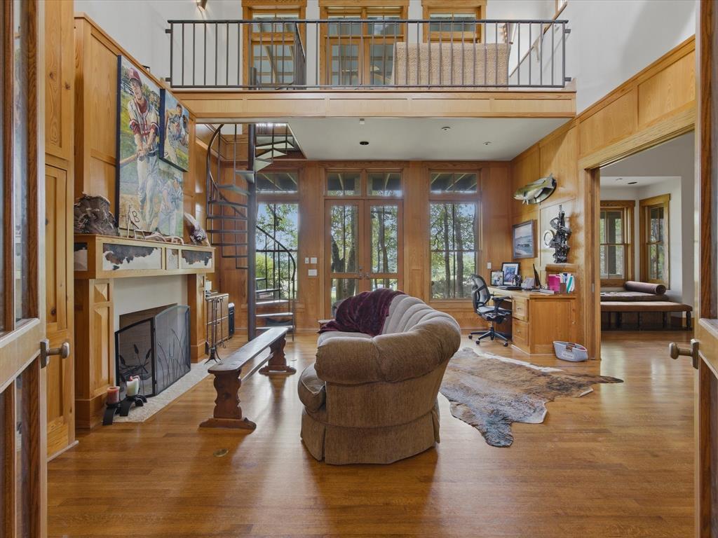151 Trinity Bluffs Road Aledo, TX 76008 - Photo 18 of 40 a living room with furniture a fireplace and wooden floor