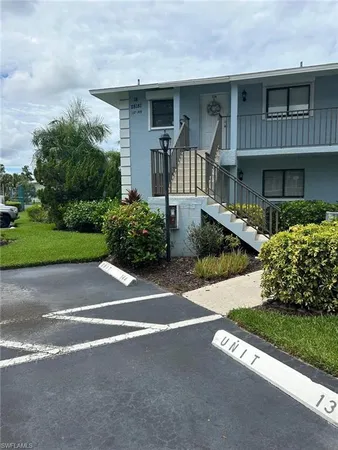a front view of a house with a yard and shrubs