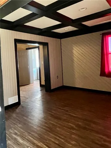 a view of a room with wooden floor and chair