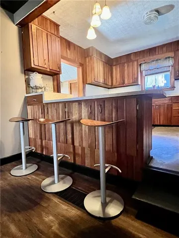 a dining room with furniture a window and wooden floor