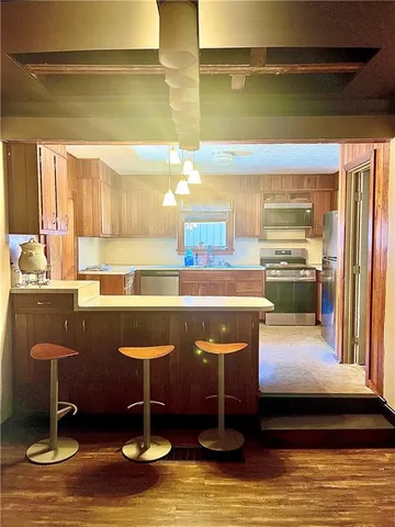 a kitchen with stainless steel appliances granite countertop a sink and a stove