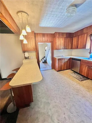 a kitchen with a sink cabinets and wooden floor