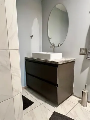 a room with a sink and a mirror