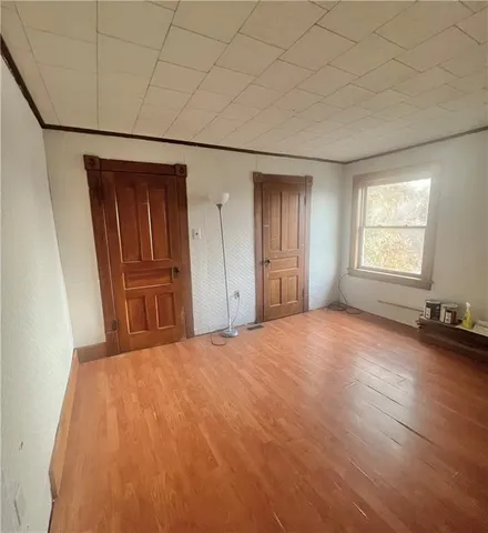 an empty room with windows and closet