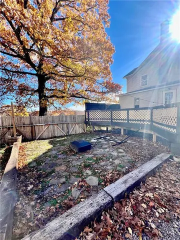 a view of a backyard with wooden fence