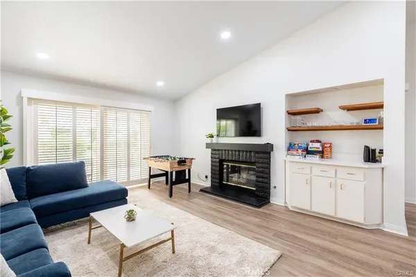 a living room with furniture fireplace and window