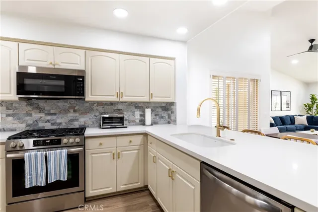 a kitchen with a sink stove and microwave