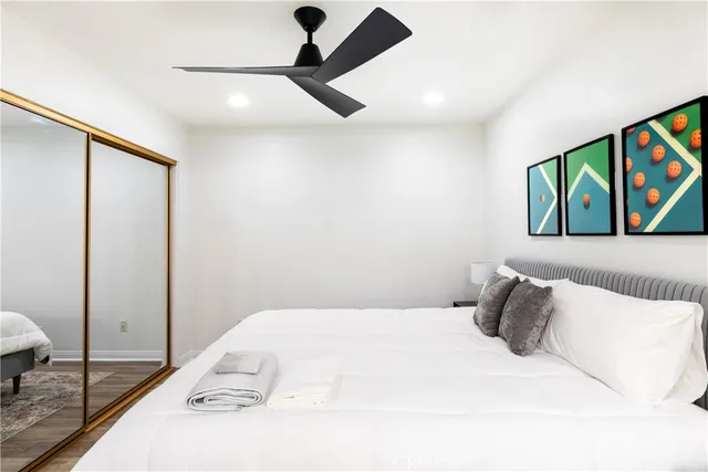 a bedroom with a bed and a painting on the wall