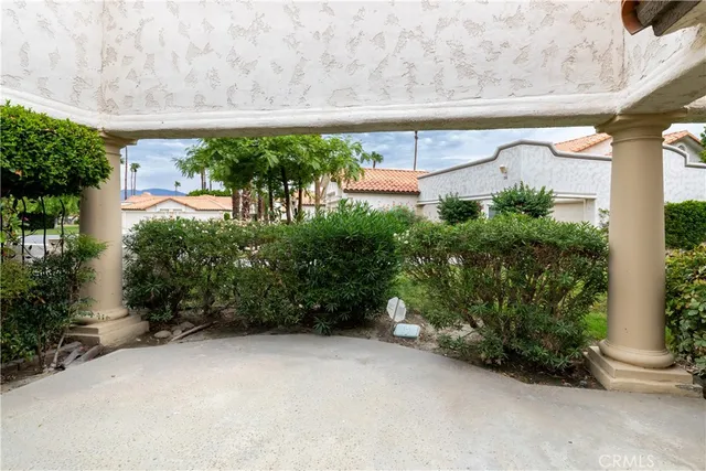a backyard of a house with lots of green space and plants