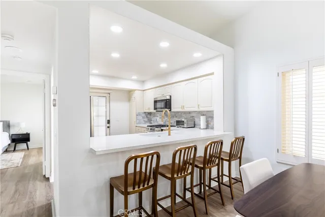 a large kitchen with a table and chairs