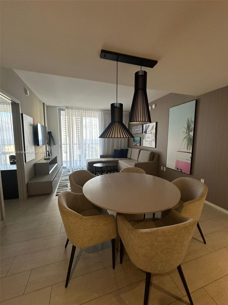 4010 South Ocean Drive, Unit R1707 Hollywood, FL 33019 - Photo 2 of 14 a dining room with furniture and wooden floor