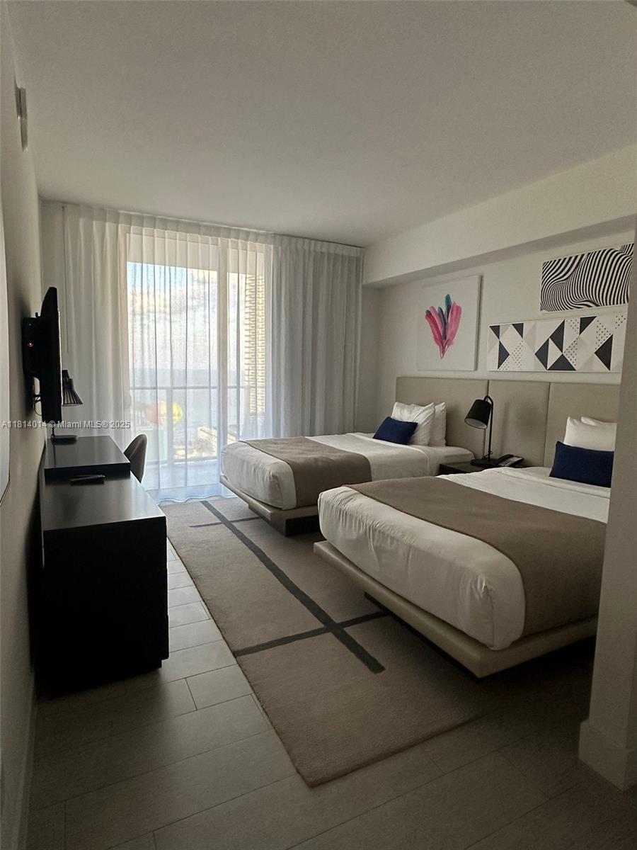 4010 South Ocean Drive, Unit R1707 Hollywood, FL 33019 - Photo 5 of 14 a bedroom with furniture and a window