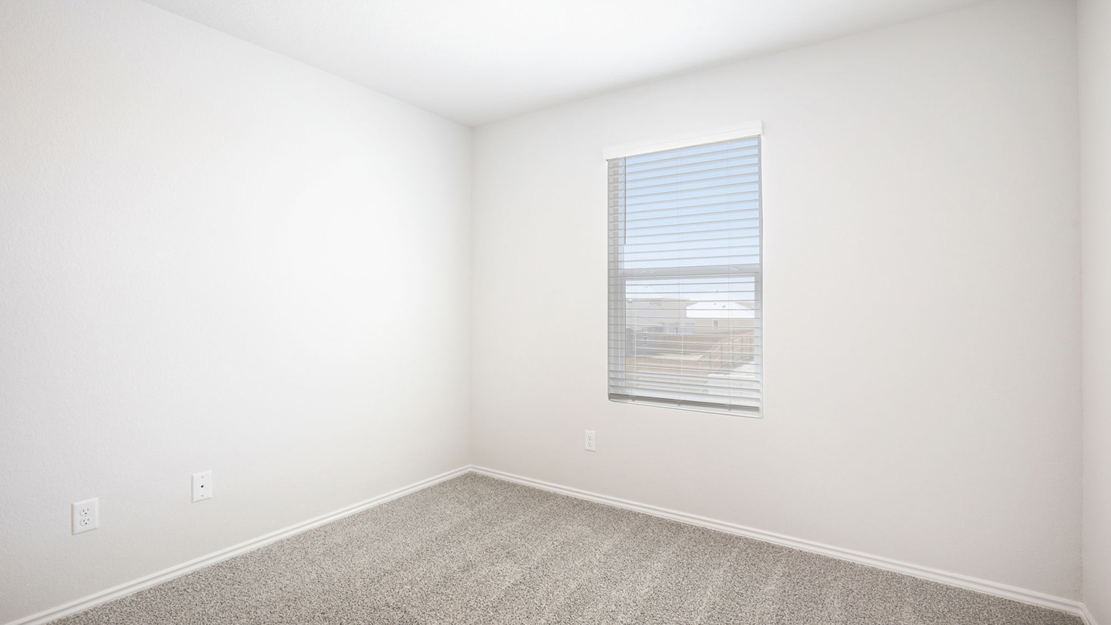 133 Wyatt Way Jarrell, TX 76537 - Photo 28 of 32 Bright room featuring light gray carpeting, white baseboards, and a window with horizontal blinds