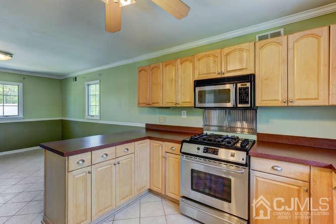 32 Ashley Road Edison, NJ 08817 - Photo 14 of 41 a kitchen with granite countertop a stove top oven microwave and cabinets